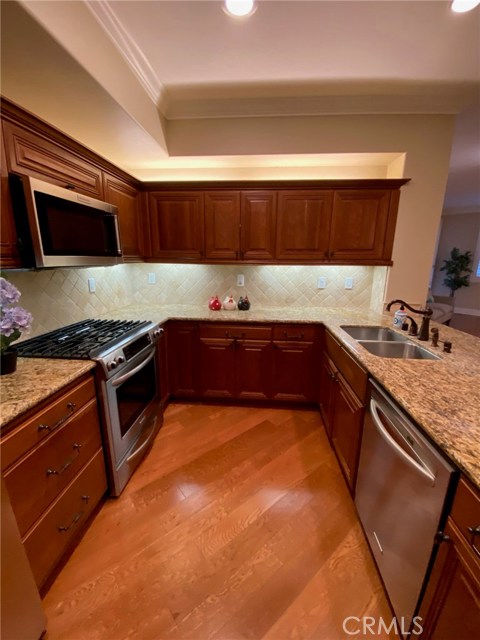 Gourmet Kitchen with Plenty of Cabinet Space. New Stainless Microwave above the Stainless Slide-in Stove. Stainless Dishwasher. Stainless Dual Sink. Wood Floors.