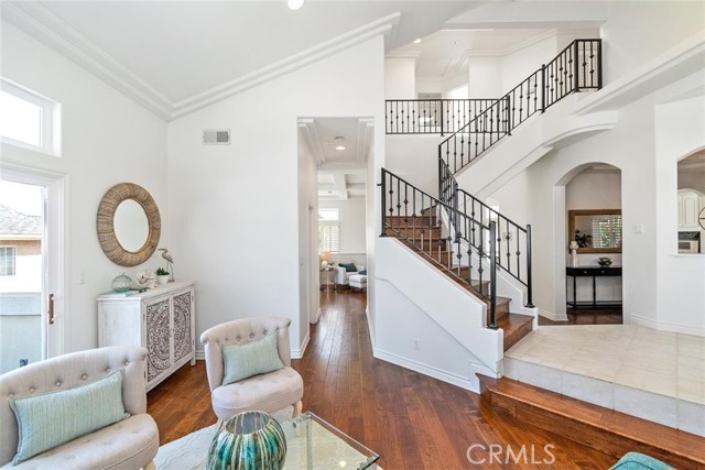 Living room view towards powder room, great room, stairs to bedrooms, and formal dining space.
