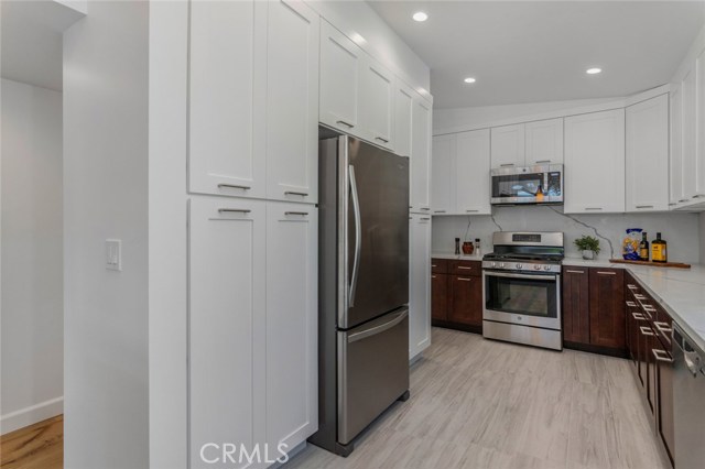 Self closing, shaker cabinetry throughout this walk-through kitchen.