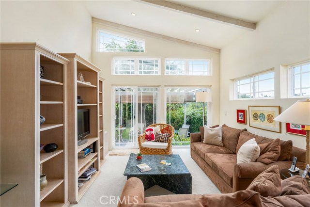 Family room with wall of glass looking out towards the beautiful back garden! Vaulted ceilings, recessed lighting, beautiful dual paned windows!