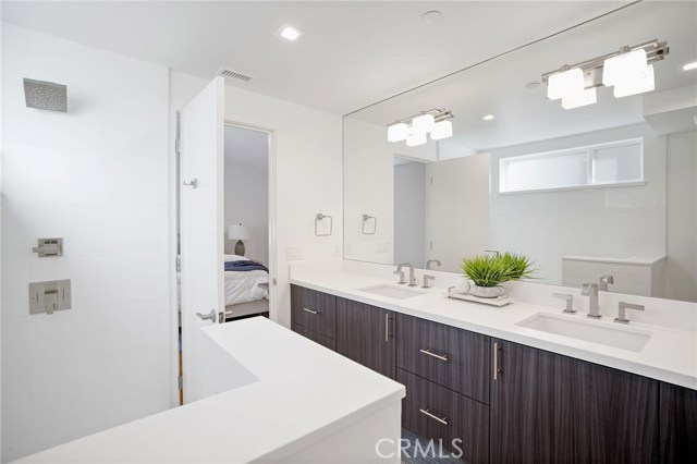 Master bath with floating cabinets, quartz countertop