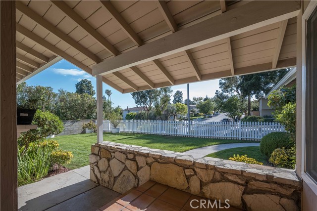 Nice green grass front yard enclosed by a white picket fence