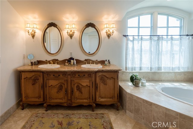 Master Bathroom with Antique Austrian Cabinet and Dual Sinks