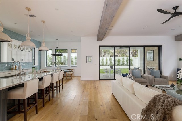 Blonde white washed hardwood floors warm up the great room