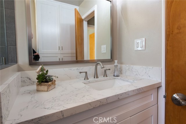CENTRAL/BACK BATHROOM QUARTZ COUNTER TOP & BACKSPLASH - SATIN NICKEL FRAMED VANITY MIRROR