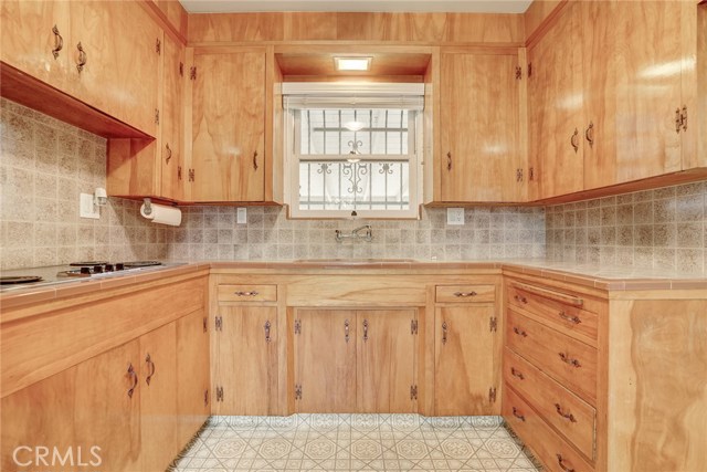 View looking towards the window over the kitchen sink. The window looks out to the back covered patio.