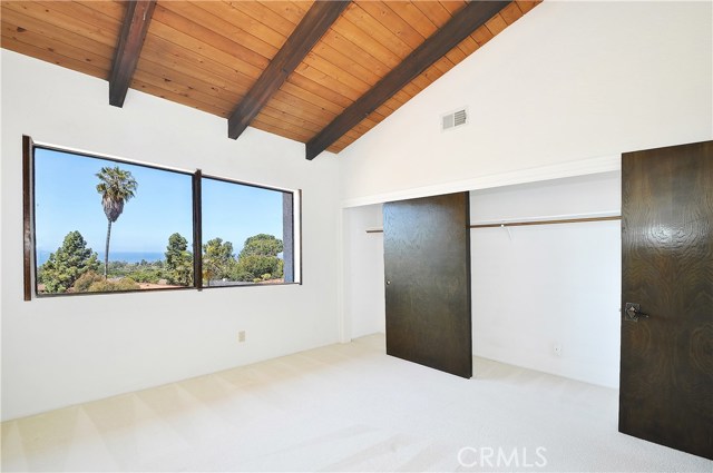 Bedroom 2 with ocean views and vaulted ceiling