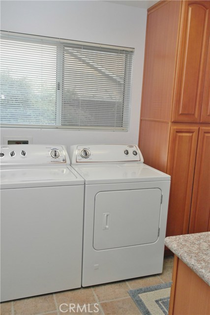 Laundry Room Includes Sink, Folding Counter And Plenty Of Cabinets.