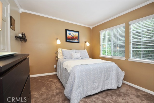 Downstairs Bedroom #1 has new paint, carpeting, smooth ceilings, crown molding and Dual pane windows