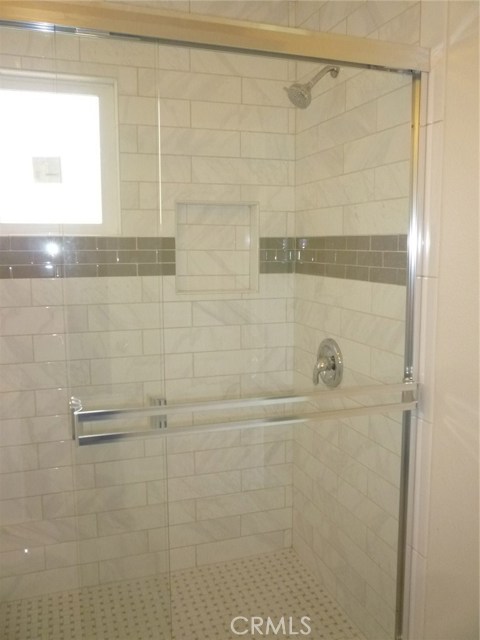 Bedroom 1 walk-in shower with beautiful tile work.