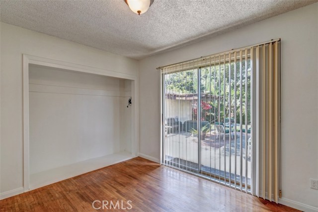 Master bedroom with alcove that was used as shelf space could be additional closet.