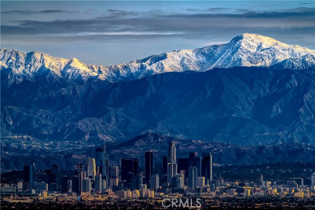 Enhanced view of downtown dwarfed by snowcapped mountains