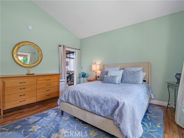 Master bedroom with high ceiling and glass door to patio.