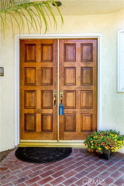 Double front door entry, brick walk way with room for flower gardens.