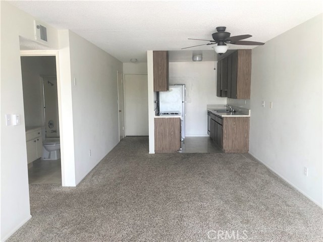 View of unit entrance, kitchen, and bathroom from the living room