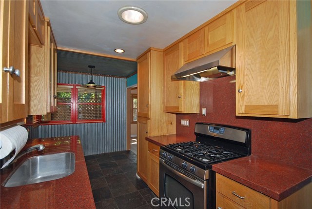 Remodeled kitchen! The galley kitchen boasts granite counters and slate flooring!