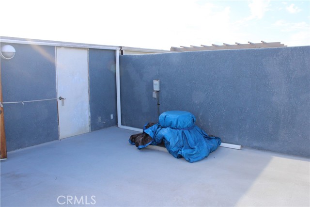 air conditioning compressor and door to attic and additional storage.