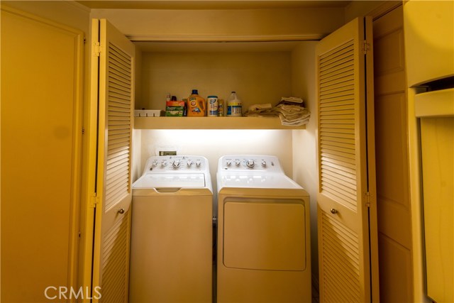 Laundry area located off kitchen, accordian doors. New washer/dryer included.