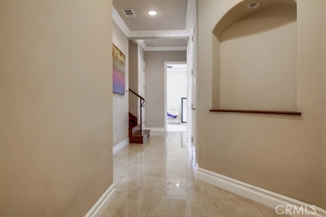 Tile floors that shine, crown moulding, and recessed lighting lead you to the two downstairs bedrooms