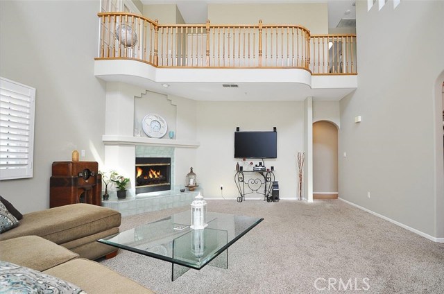 Gorgeous living room with vaulted ceiling and carpeting is at the rear of the home or make it the family room!