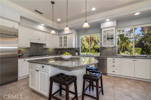 Kitchen has Stainless Appliances and large Island with counter seating.
