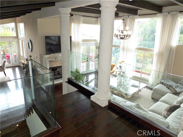 The entryway leads you to a view of the sunken living room and dining area (left)