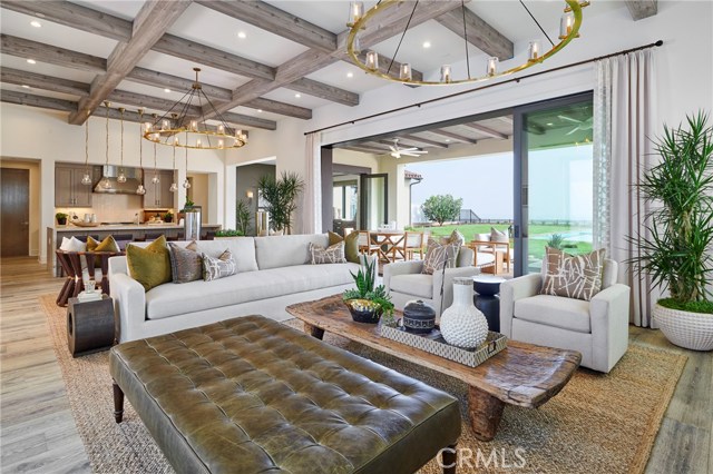 Great room with high beamed ceiling opens to kitchen, dining room and courtyard. Same floorplan as model home, shown.
