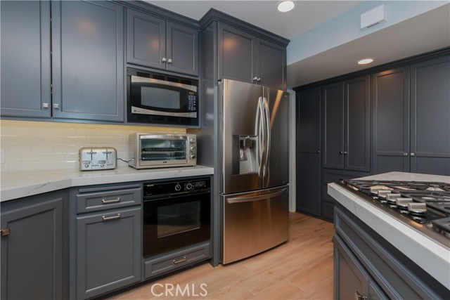 Kitchen - Remodeled kitchen with Porcelain Wood Flooring