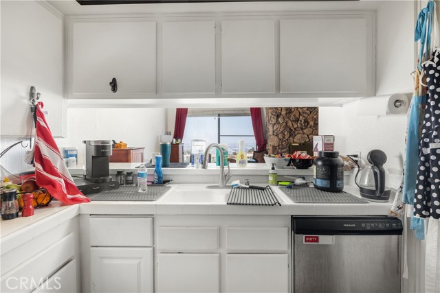 Kitchen looks through dining room to view