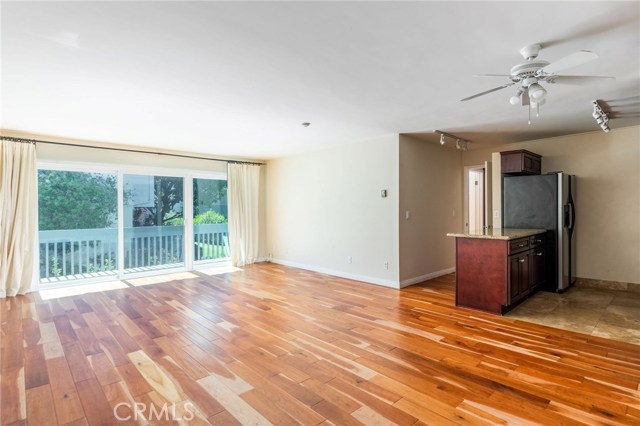 Bright, open concept living space with hardwood floors and courtyard views