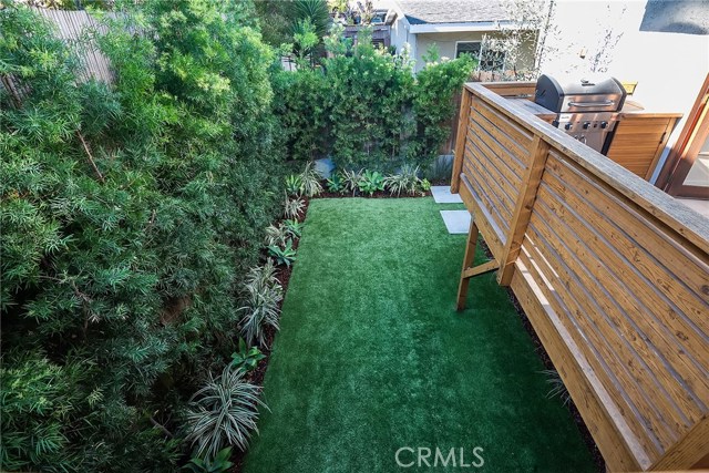 LUSH BACKYARD WITH LOW MAINTENANCE TURF PROVIDES PLENTY OF SPACE TO RUN AROUND OR SET UP ADDITIONAL ENTERTAINING SPACE. STORAGE SHED IS LOCATED UNDER THE DECK.