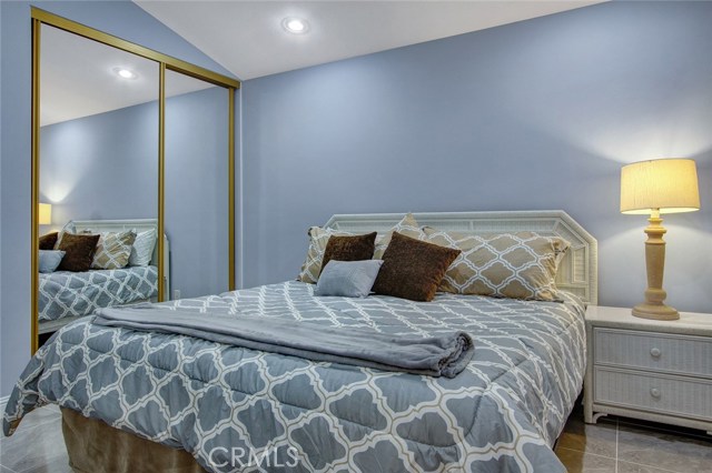 2nd bedroom with mirrored closet doors, high ceilings & recessed lighting.