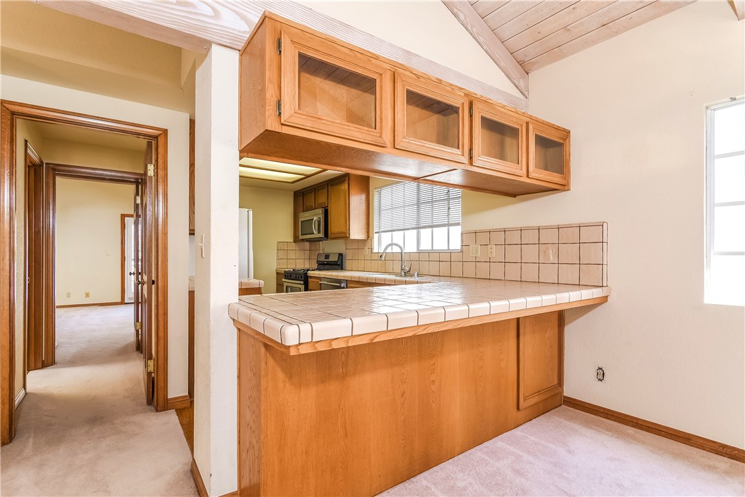 The adjoining kitchen has a deep and wide bar counter and with stools it is a great breakfast area.