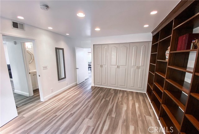 Downstairs bedroom/office with plenty of closet space and lovely hardwood bookshelf