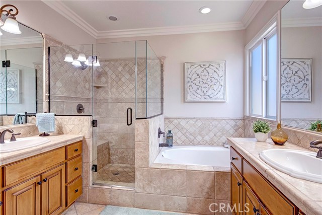 En-suite master bathroom with walk-in shower, separate jetted tub, dual sinks and counter space.