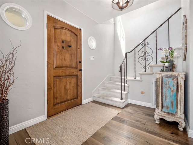 Beautiful formal entry - Notice to gorgeous iron work on the staircase.