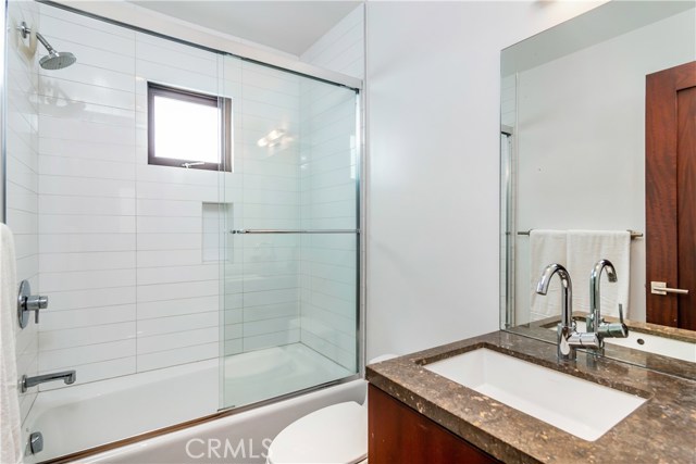 Guest suite bathroom with Ann Sacks tiles Granite counters and mahogany cabinets