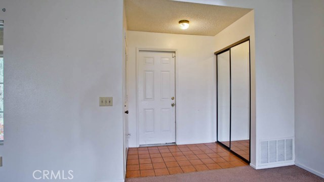 Front Entry with Mirrored coat closet and access to large Garage area