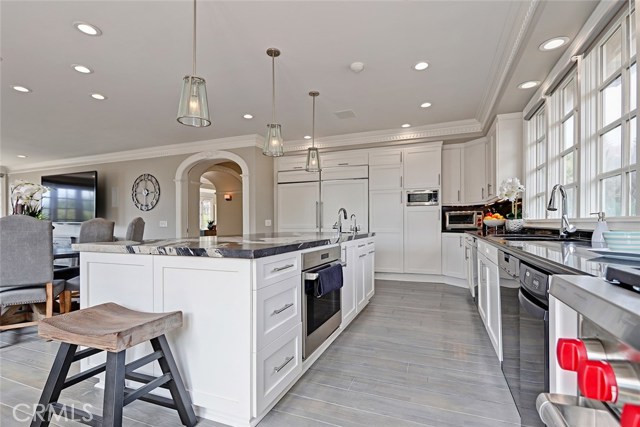 Warm and joyful, the Kitchen features white cabinetry, black granite countertops, Subzero and Wolf appliances, and a stunning Marble Island. Sit along the Island, or at the Kitchen table for morning coffee.