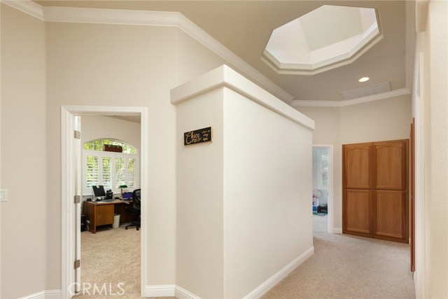 Hallway showing skylights and extra cabinets in this home.