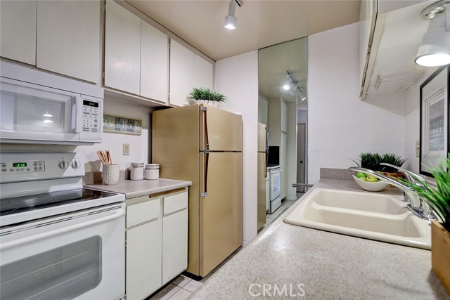 Galley kitchen with lots of cabinet space and countertops made for food prep.