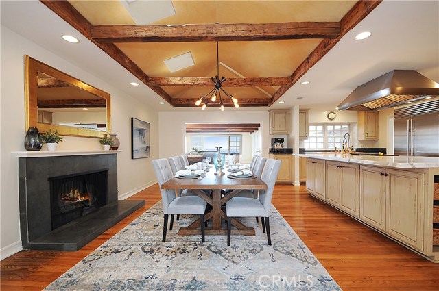 Dining room with fireplace (one of 4 fireplaces) hardwood floors, all open to the wonderful kitchen and family room to make an open great room feel.