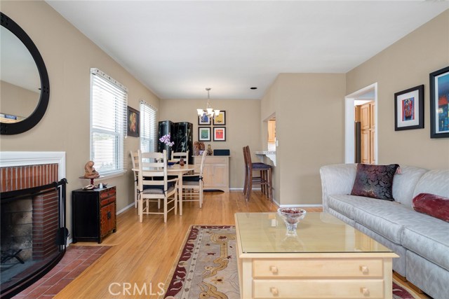 Living room has fireplace, oak floors and dining area + breakfast bar that is open to kitchen.