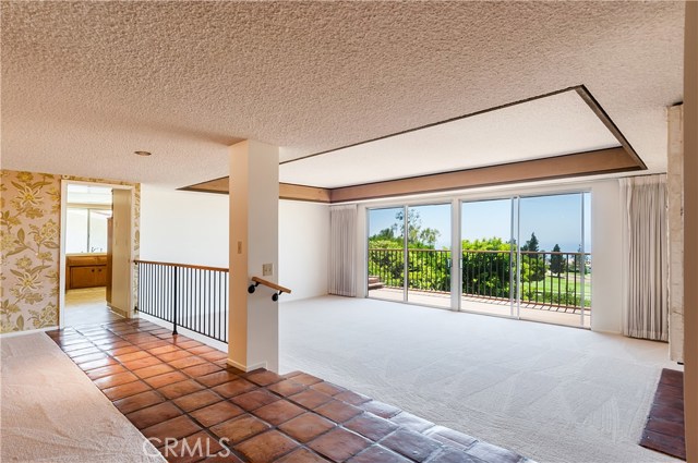 Large living room with fireplace and glass doors overlooking the view.