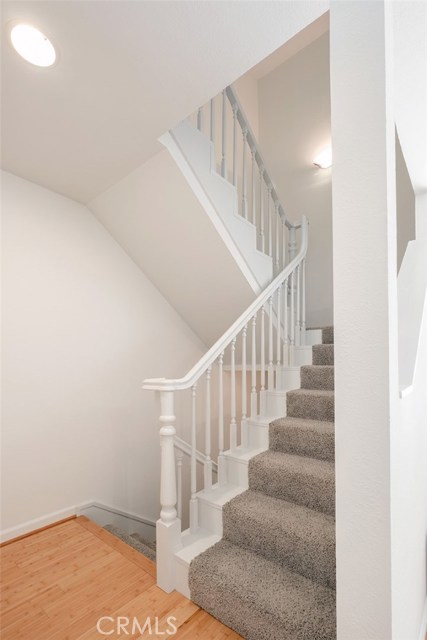 Stairway from living level to bedroom; new carpet, freshly painted, stairs to garage are to the left