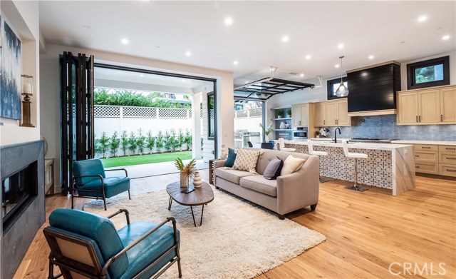 The spacious Great Room with 11' ceiling. A huge 14' wide "Cantina" door stacks open to easily flow to the back patio and yard to expand your living area.