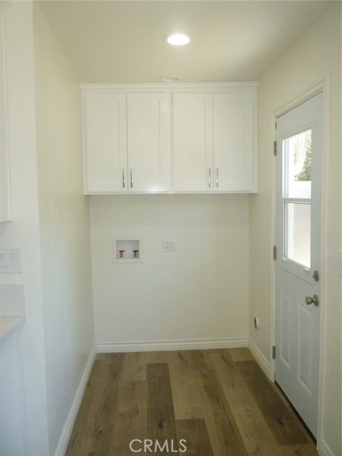Laundry area off of the kitchen.  Door on right leads to the side yard.