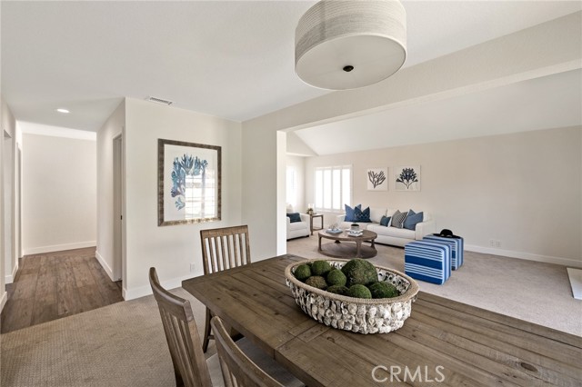 Dining room leading into the hallway and powder room.