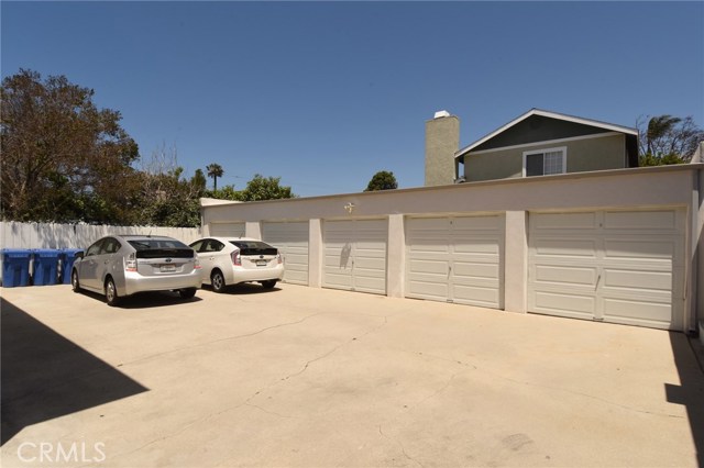 Rear garage area.  5 private garages with separating walls.  All have roll-up doors, 2 with remotes.