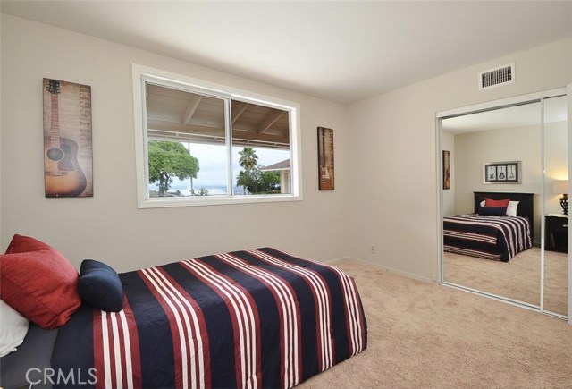 3rd Bedroom with City Light View, new Mirror Closet Doors, neutral carpeting and paint.